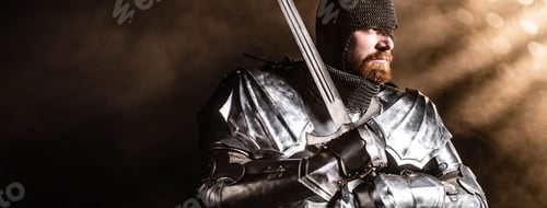 Preview: panoramic shot of handsome knight in armor holding sword on black background