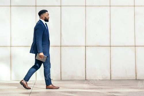 Preview: black businessman in a suit using a tablet