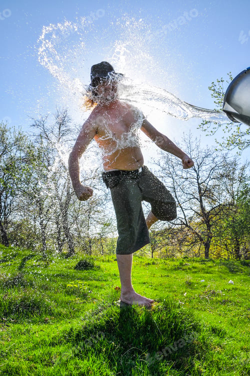 Preview: Ice bucket challenge. Man pours iced water from a bucket