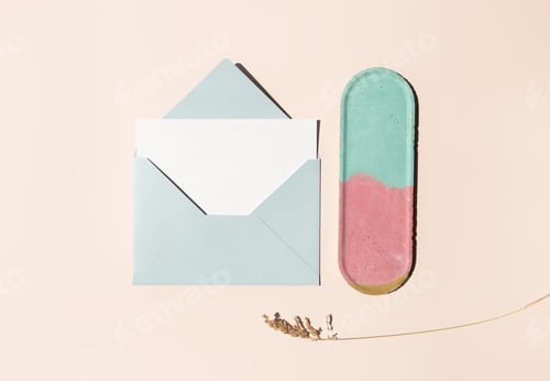 Preview: Blue mail envelope, blank white paper letter, dry herb and empty colorful concrete decor plate