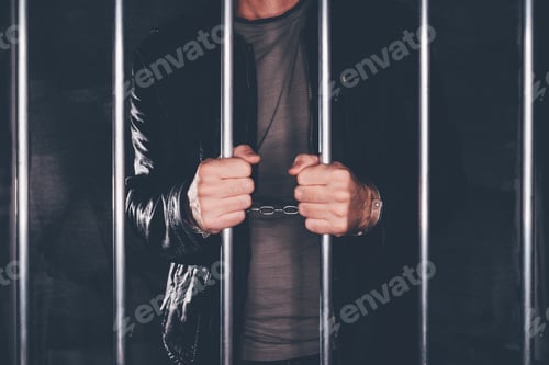 Preview: Handcuffed man behind prison bars