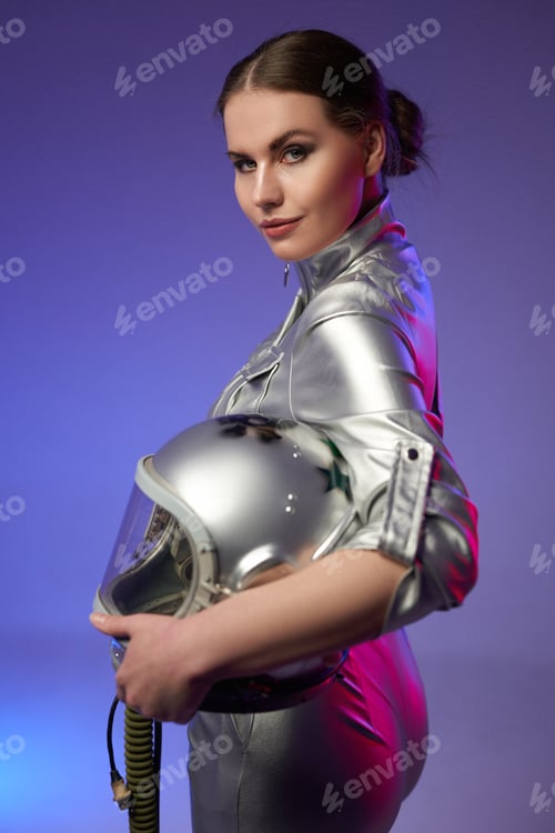 Preview: Space woman holding helmet against purple background