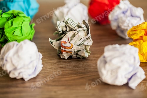 Preview: Great idea concept. Crumpled colorful paper on wooden table