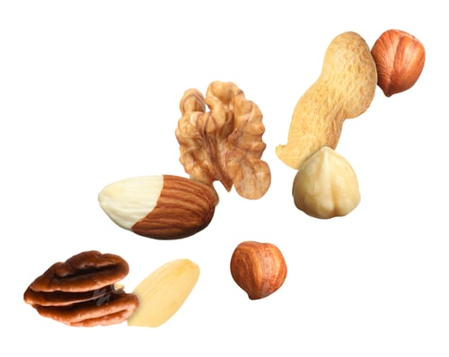 Preview: Many different nuts in air on white background