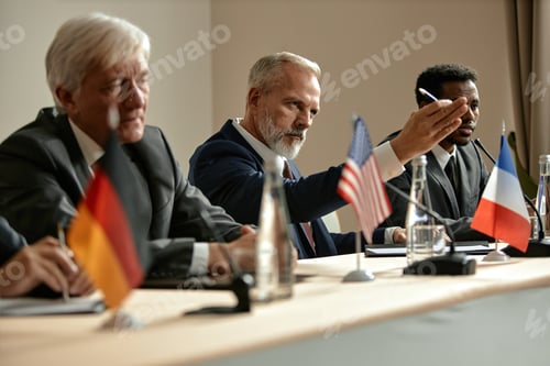 Preview: Middle Aged Caucasian Man Gesturing during International Political Conference