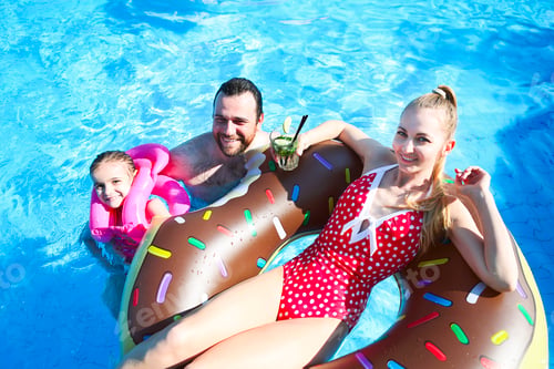 Preview: Happy family having fun in pool