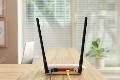 Preview: Modern wi-fi router on wooden counter indoors