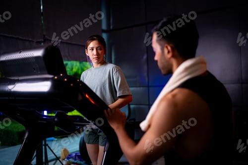 Preview: Asian man and woman working out, one is a trainer, the other is an exerciser