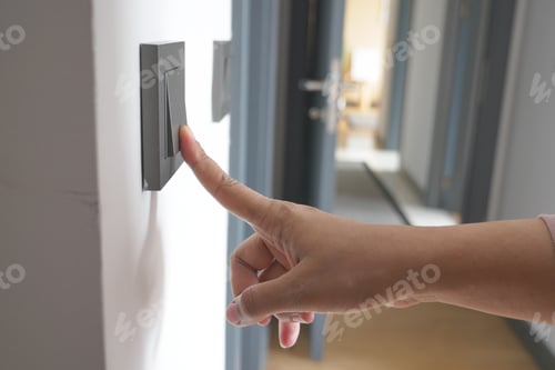 Preview: A finger turning on lighting switch .