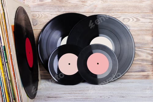 Preview: Vinyl record in front of a collection of albums. Copy space for text.