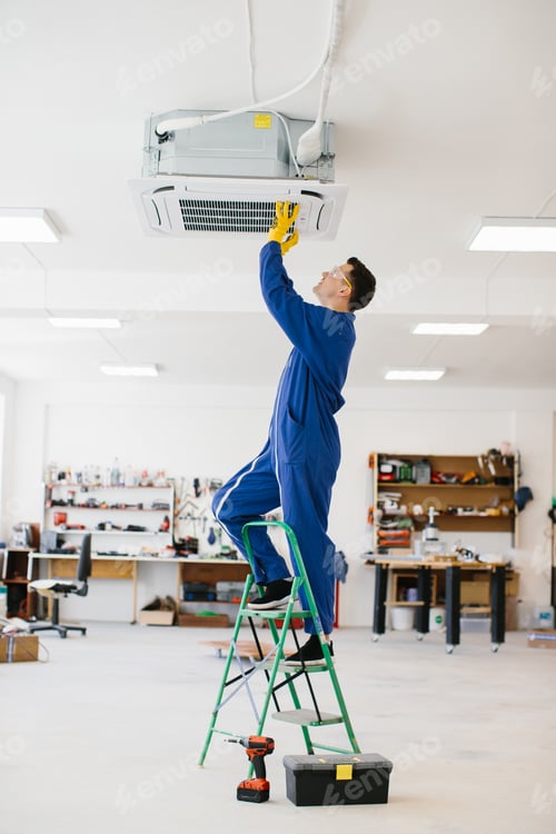 Preview: Electrician installing air conditioning unit on a ladder