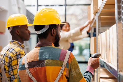Preview: African american logistics managers scanning freight in storage department