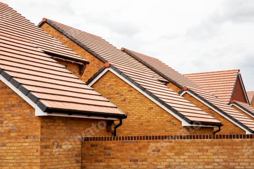 Preview: Exterior view of yellow brick row house with yellow roof tiles.