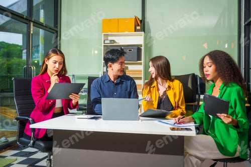 Preview: Asian colleagues, middle-aged man and young woman, happily collaborate in office workplace