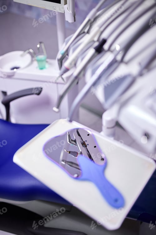 Preview: Modern metallic dentist tools and burnishers on a dentist chair