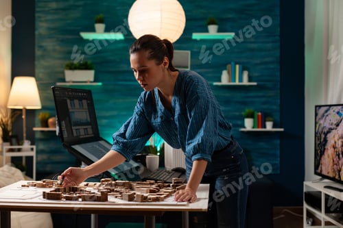 Preview: Modern caucasian engineer standing at table analyzing
