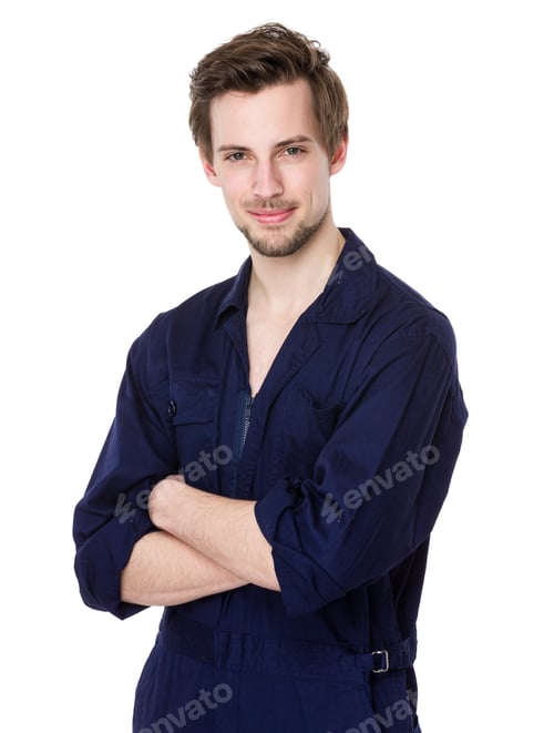 Smiling Man in Blue Coveralls With Arms Crossed