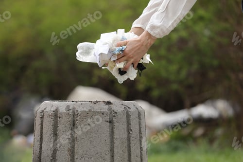 Preview: woman throws plastic garbage in the trash. woman hand picking up garbage plastic for cleaning
