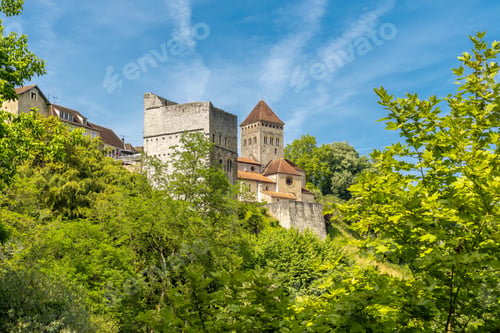 Preview: Sauveterre de bearn church towering over lush green trees in france