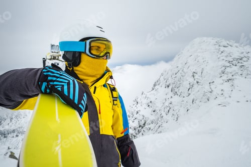 Preview: woman skier posing on the top of snowed mountain