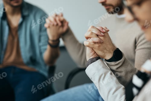 Preview: Close-up of people holding hands and supporting each other during group therapy session.