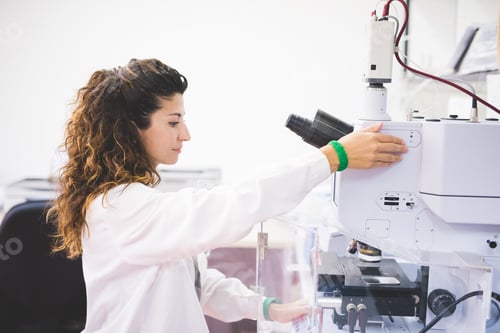 Preview: Female scientist using FTIR spectrophotometer, focusing sample on microscope camera,