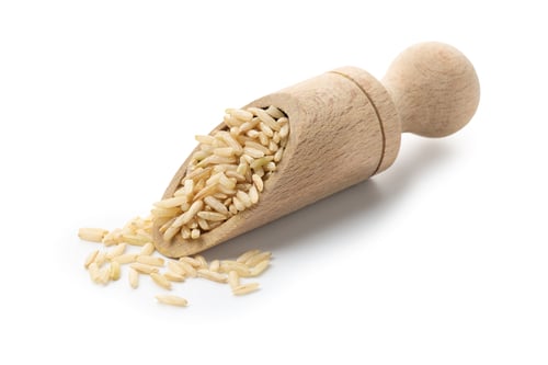 Preview: Raw brown rice and scoop isolated on white