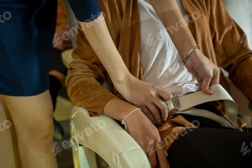 Preview: Cabin crew or air hostess seat belt for a safe trip of passengers in planes.