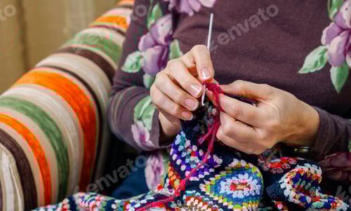Preview: Adult Crocheting Cozy Colorful Blanket Indoors