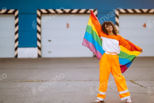 Preview: African American lesbian woman holding LGBT rainbow flag. The concept of happiness, freedom.