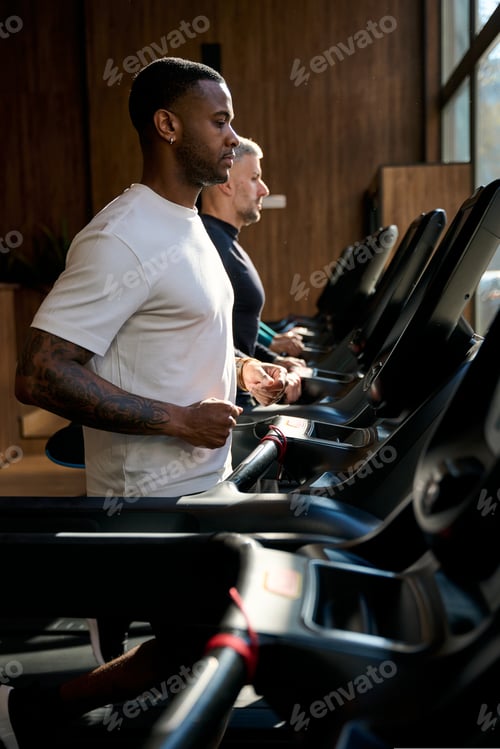 Preview: Men exercising on treadmills in a gym