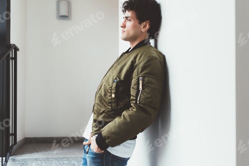 Preview: Man in Bomber Jacket Leans Against Wall
