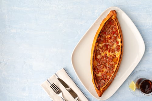 Preview: Turkish baked Pide bread on light blue wooden surface