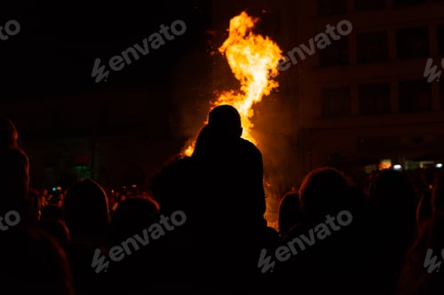 Preview: group of people enjoying a bonfire in a festive atmosphere.