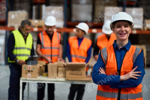 Preview: Happy warehouse worker smiling with diverse team