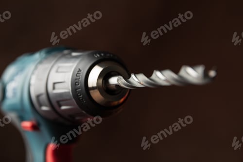Preview: Cordless drill on brown background, close up