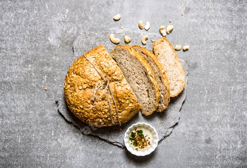 Preview: Fresh bread on a stone pedestal. Top view