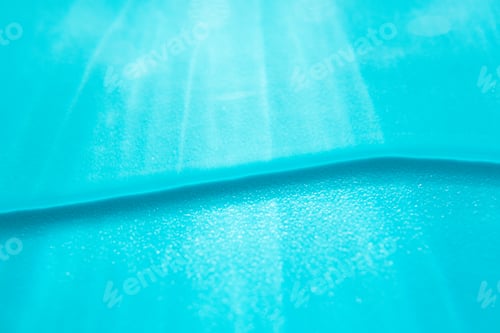 Preview: Water wave and sun rays blur abstract summer background, close-up. Blue shiny backdrop