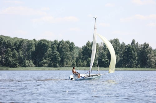 Preview: Yacht on the lake against the background of the forest and blue sky