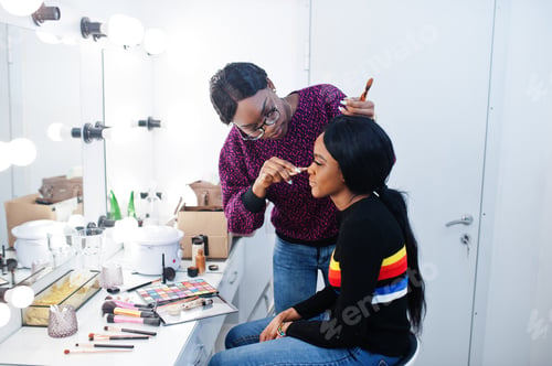 Preview: African American woman applying make-up