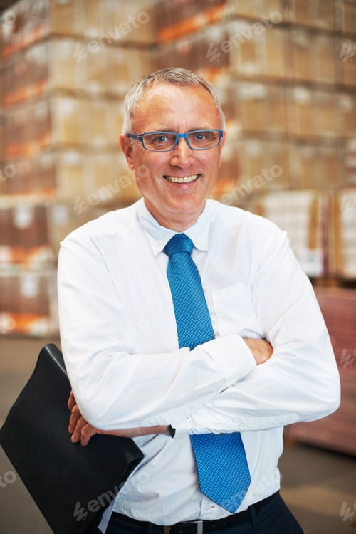 Preview: A storage warehouse manager standing in the factor amidst many boxes