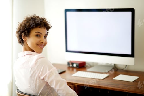 Preview: young african american woman sitting by computer screen