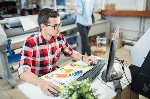 Preview: Designer working on computer in office