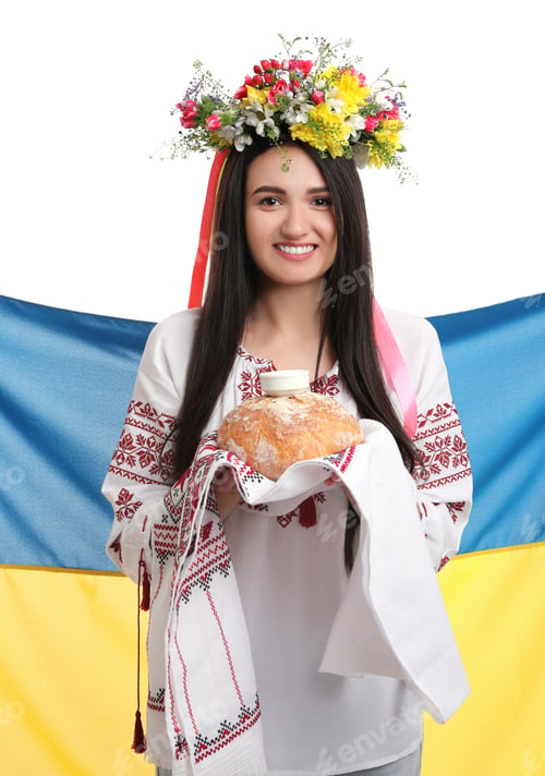 Preview: Young woman in national clothes with traditional korovai and flag of Ukraine on white background