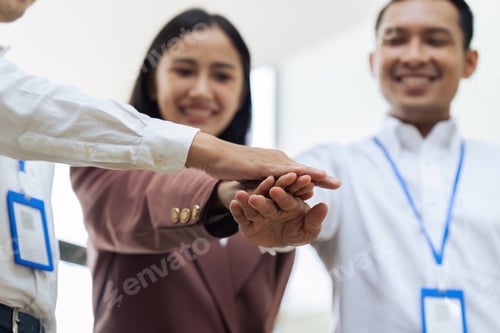 Preview: Closeup hand of Businesspeople unity between business people with their hands stacked for project