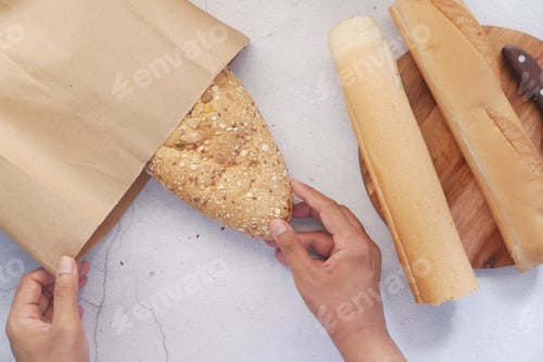 Preview: top view of baked bread and paper bag on table