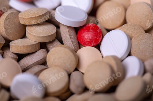 Preview: Close up with a red pill surrounded by white and gray pills