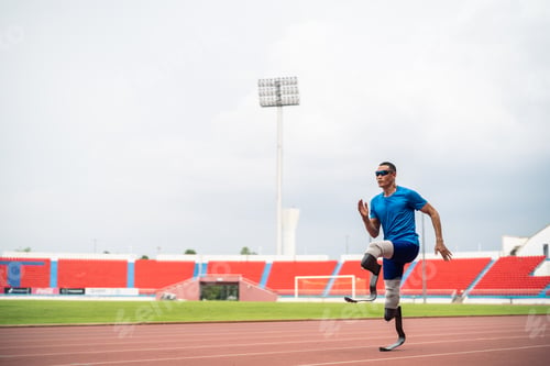 Preview: Asian para-athletes disabled with prosthetic blades running at stadium.