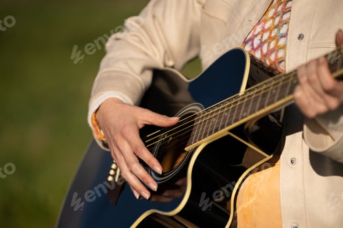Preview: Adult Plays Black Acoustic Guitar Outdoors