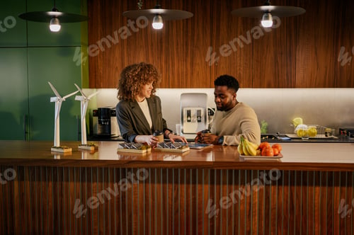Preview: Interracial environment experts collaborating on sustainable project.